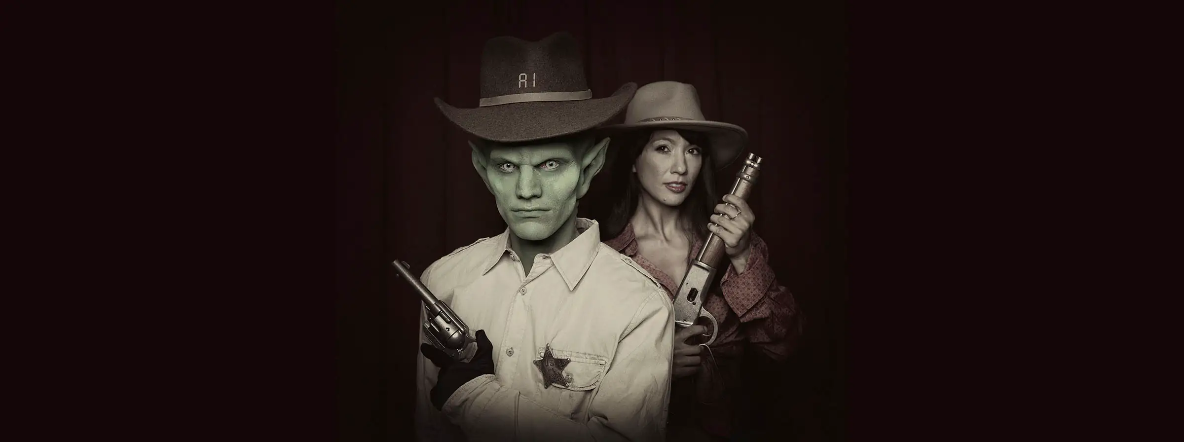 alien looking ai sheriff with long years and green face, female human deputy offset behind him, both with guns