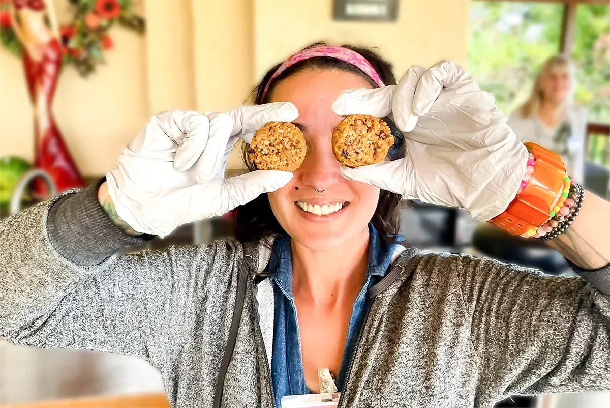 natalie smiling with two cookies in front of her eyes