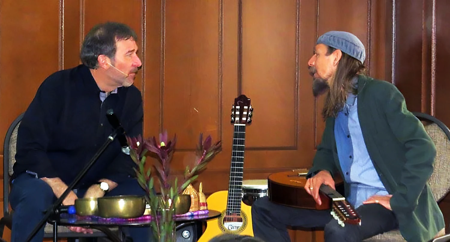 a photo of geoff hoppe and gerhard fankhauser talking to each other on stage at a crimson circle event