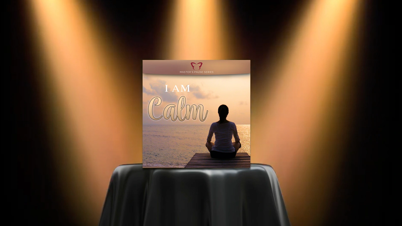 spotlight graphic: bar table with black cloth highlighted by three spotlights, with "i am calm" product cover presented on top of table