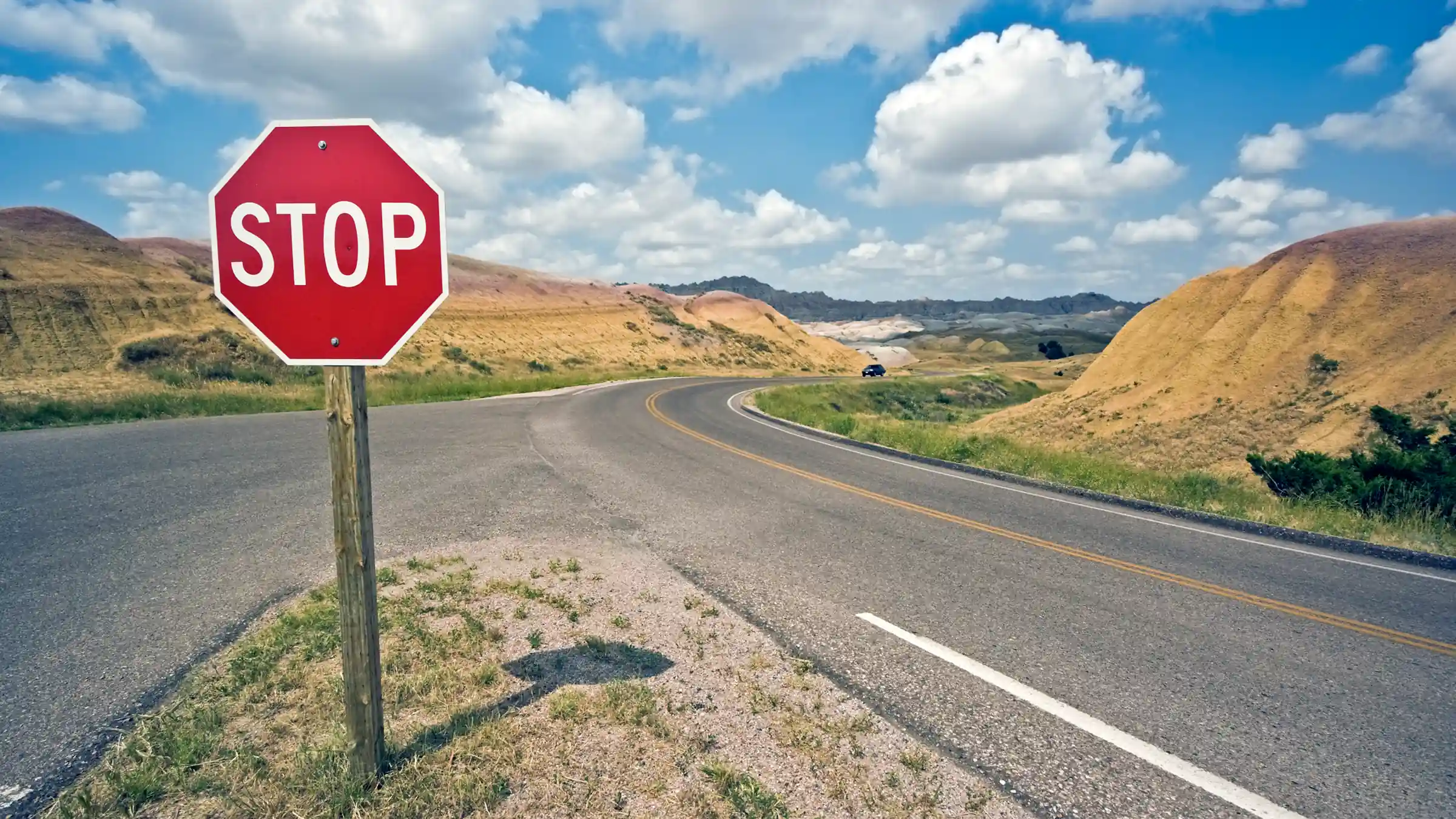 a stop sign at a crossroads in the western united states